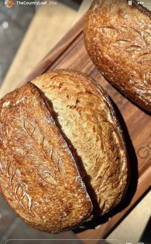 Authentic artisan sourdough country loaf with open scoring and blistered crust